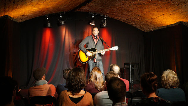 Me, onstage at the Caustic Comedy Club in Carouge, Switzerland! Photo by Jen Kirwin :-)