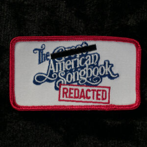 closeup of American Songbook: Redacted patch on black background