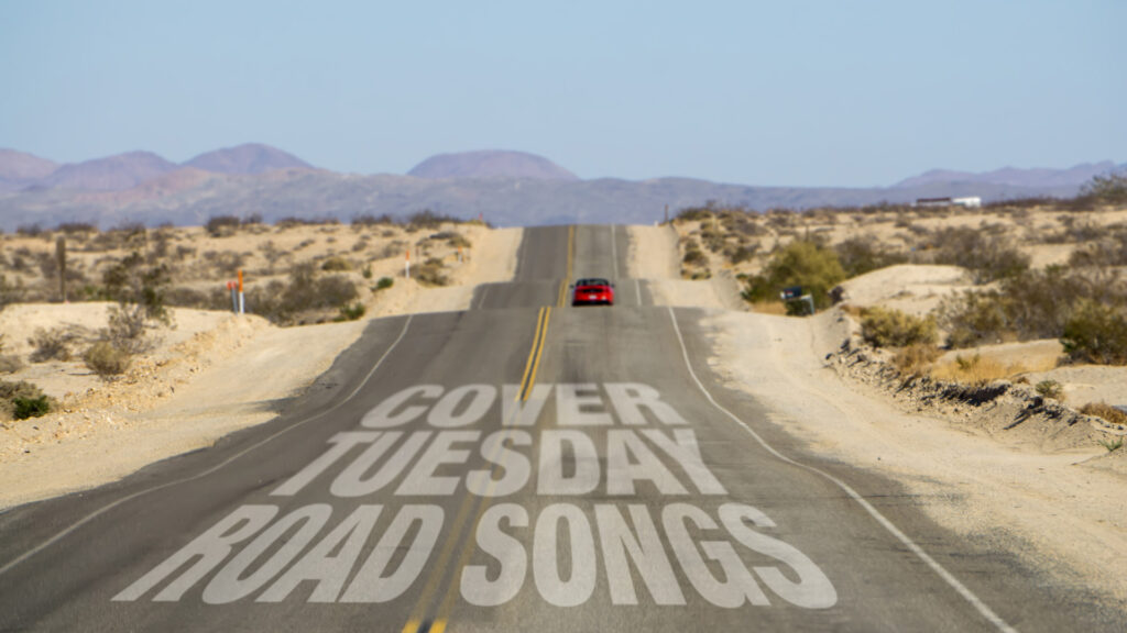 Landscape picture of a desert highway, undivided, mountains in the distance, a red car driving away about halfway down the road. On the pavement in the foreground is the headline "Cover Tuesday Road Songs"